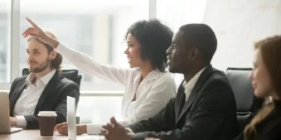 Woman raising hand in conference room