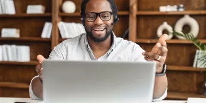 Person on a phone call looking at his laptop