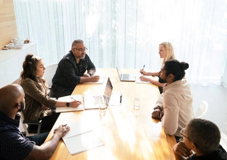 people sitting around an office table talking