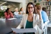 Business professional looking away during a meeting and smiling