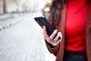 Image of a woman taking a UX test on her mobile phone