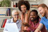 Happy coworkers looking at computer monitor